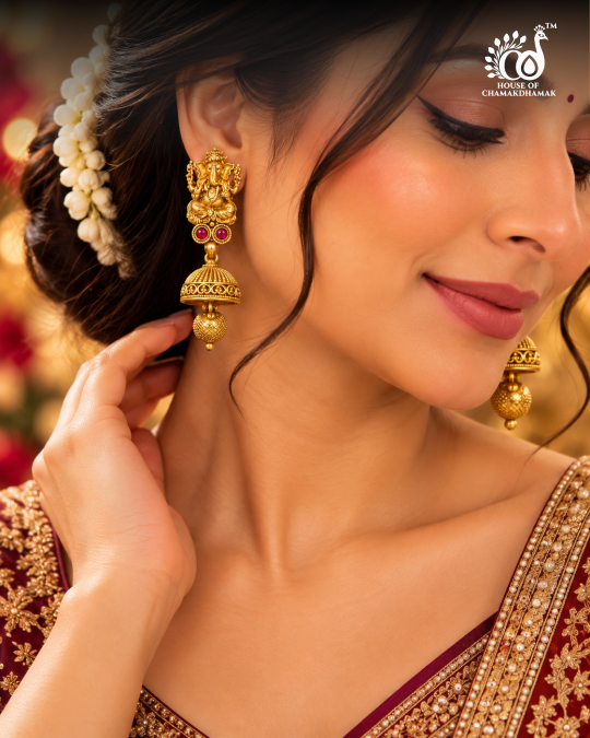 Gold Tone Temple Ganesha Jhumka Earrings with Ruby Stones and Textured Bead Drop